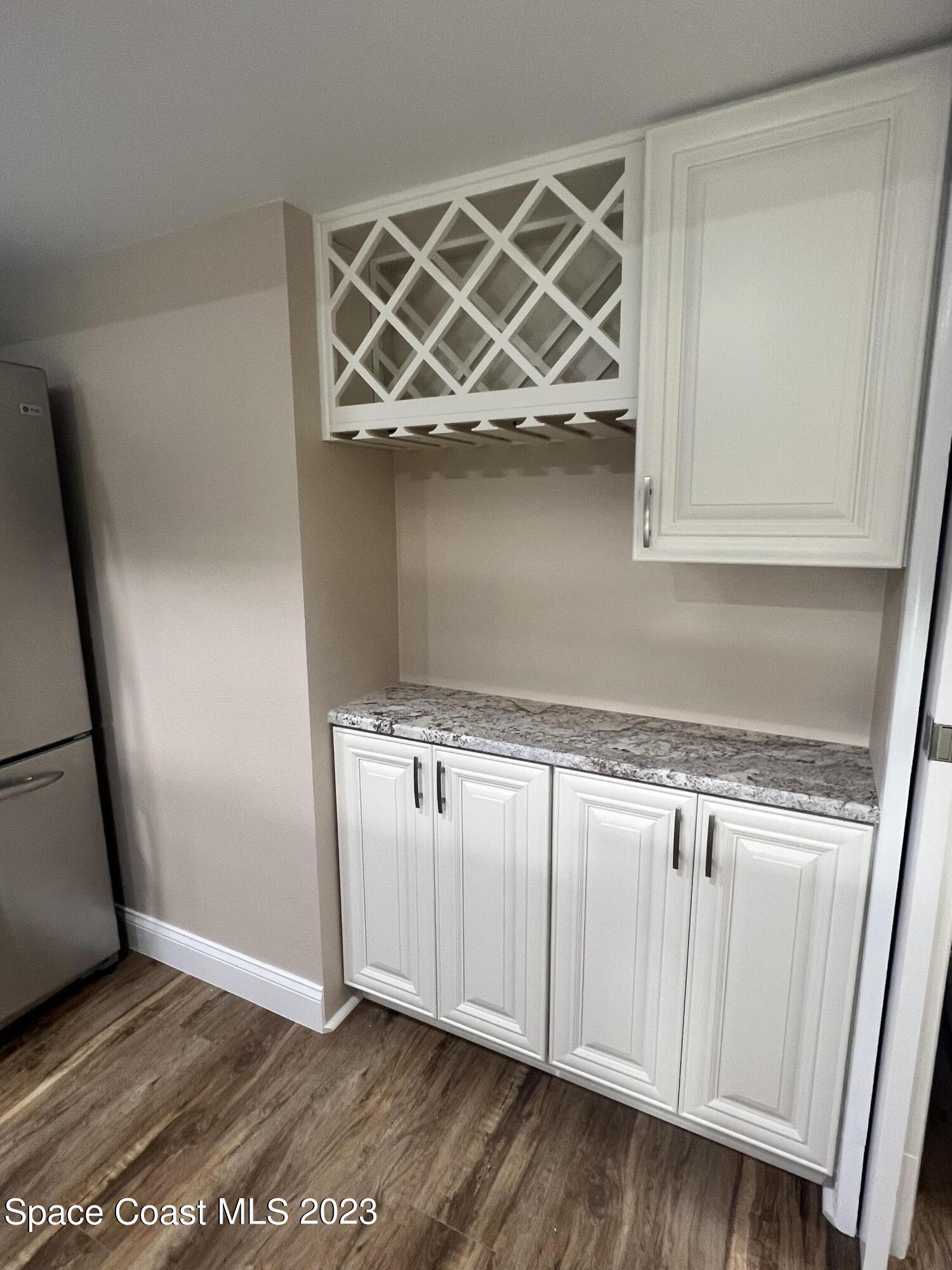161 Augusta Way Melbourne, FL 32940 - Photo 16 of 26 a view of a storage & utility room with wooden floor