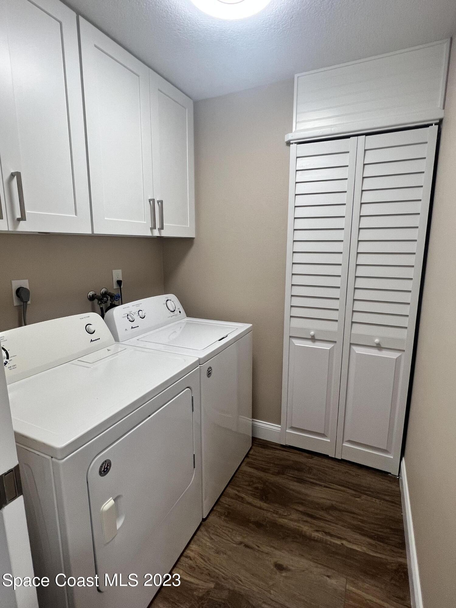 161 Augusta Way Melbourne, FL 32940 - Photo 18 of 26 a utility room with cabinets washer and dryer