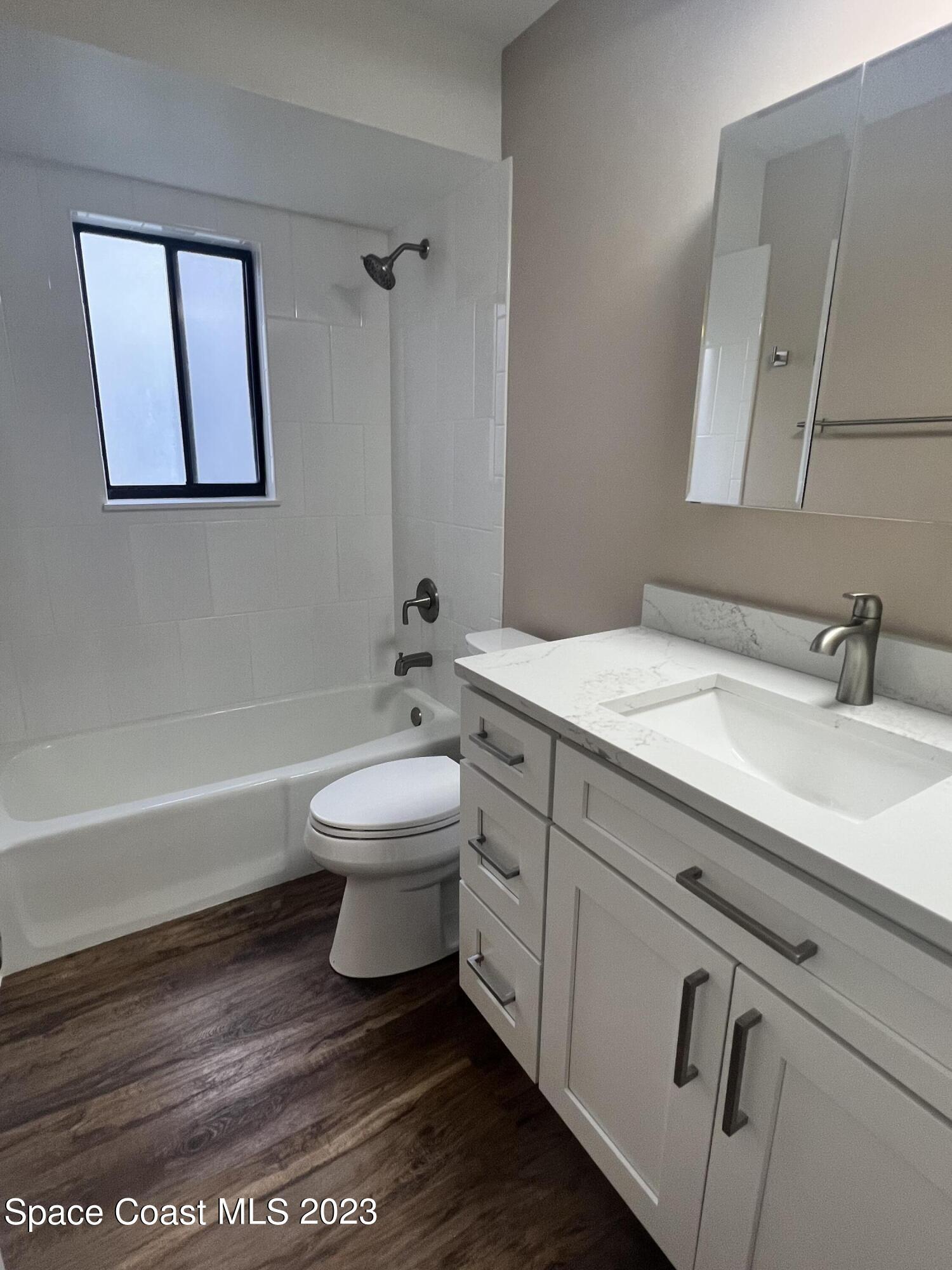 161 Augusta Way Melbourne, FL 32940 - Photo 23 of 26 a bathroom with a sink toilet and shower