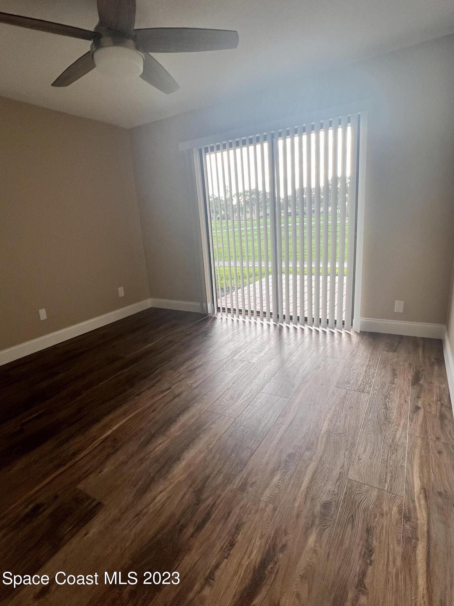 161 Augusta Way Melbourne, FL 32940 - Photo 24 of 26 a view of an empty room with wooden floor and a window