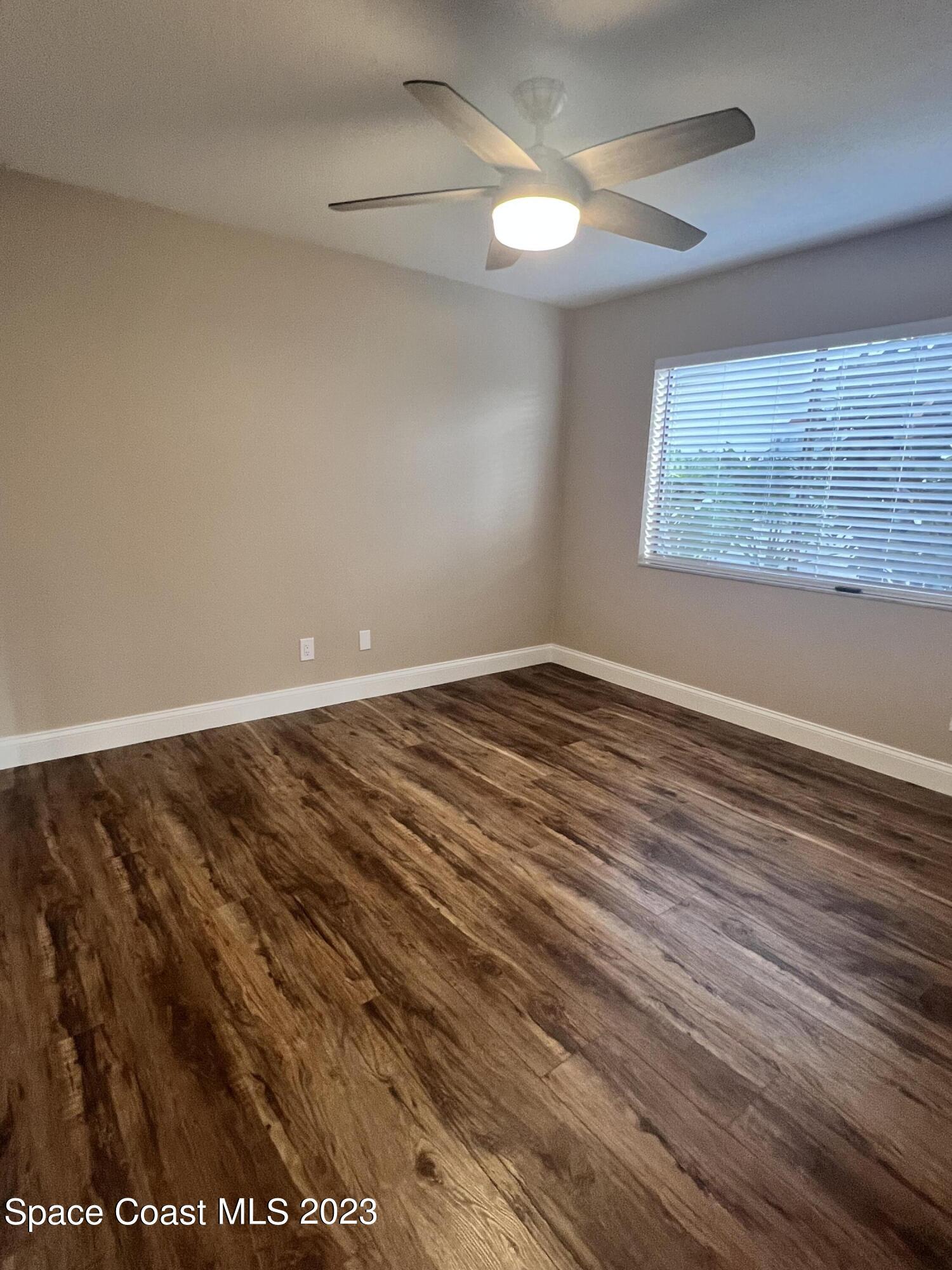 161 Augusta Way Melbourne, FL 32940 - Photo 25 of 26 a view of an empty room with wooden floor and a window