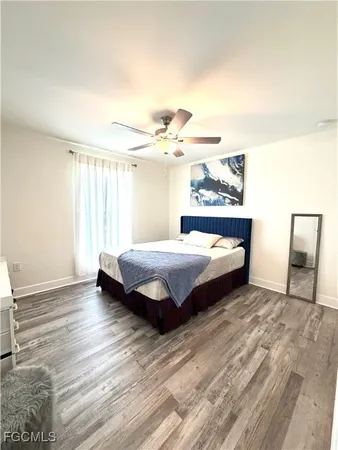a spacious bedroom with a bed and a window