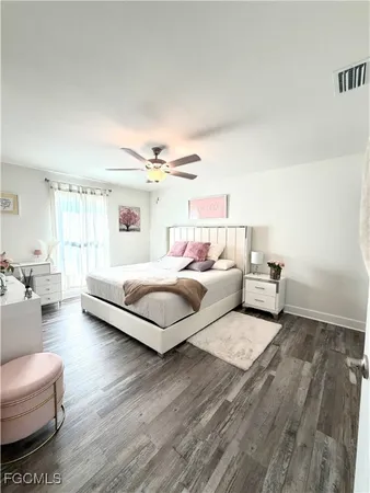 a bedroom with furniture and a large window