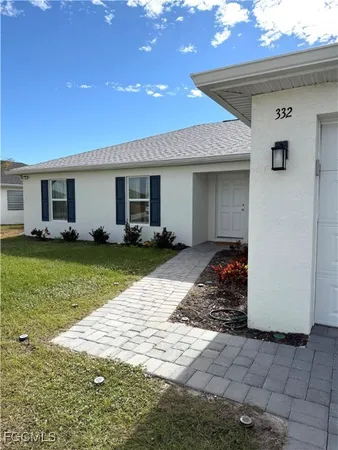a view of a house with yard and sitting area