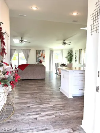 a living room with kitchen island furniture and a chandelier