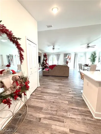 a living room with furniture and flowers