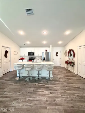 a view of a dining room with furniture and a wooden floor