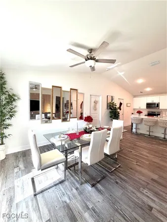 a living room with furniture and view of kitchen