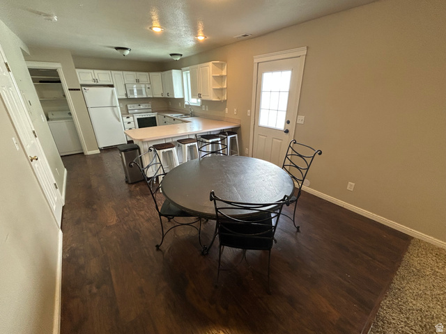 432 Spring Lane Logan, UT 84341 - Photo 8 of 22 Dining space with washer / clothes dryer and dark wood-type flooring