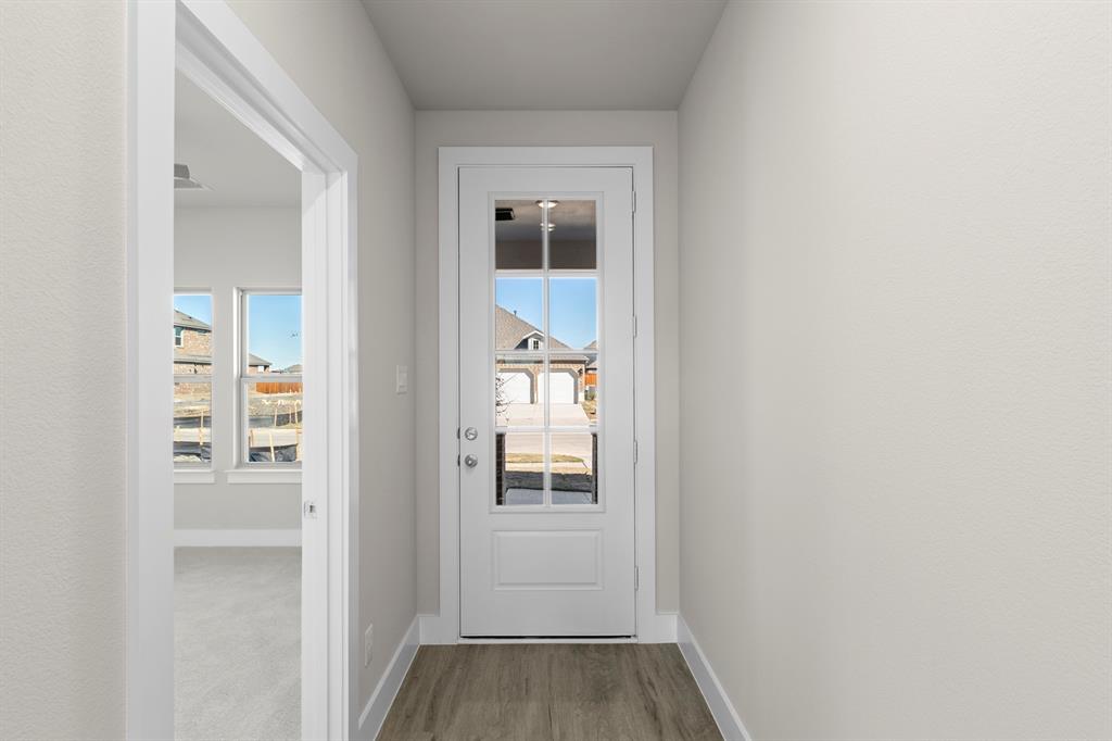 2359 Bell Way Forney, TX 75126 - Photo 22 of 31 a view of a hallway with wooden floor and a bathroom