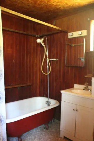 a bathroom with a sink a bath tub and shower