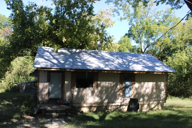 a view of house with backyard