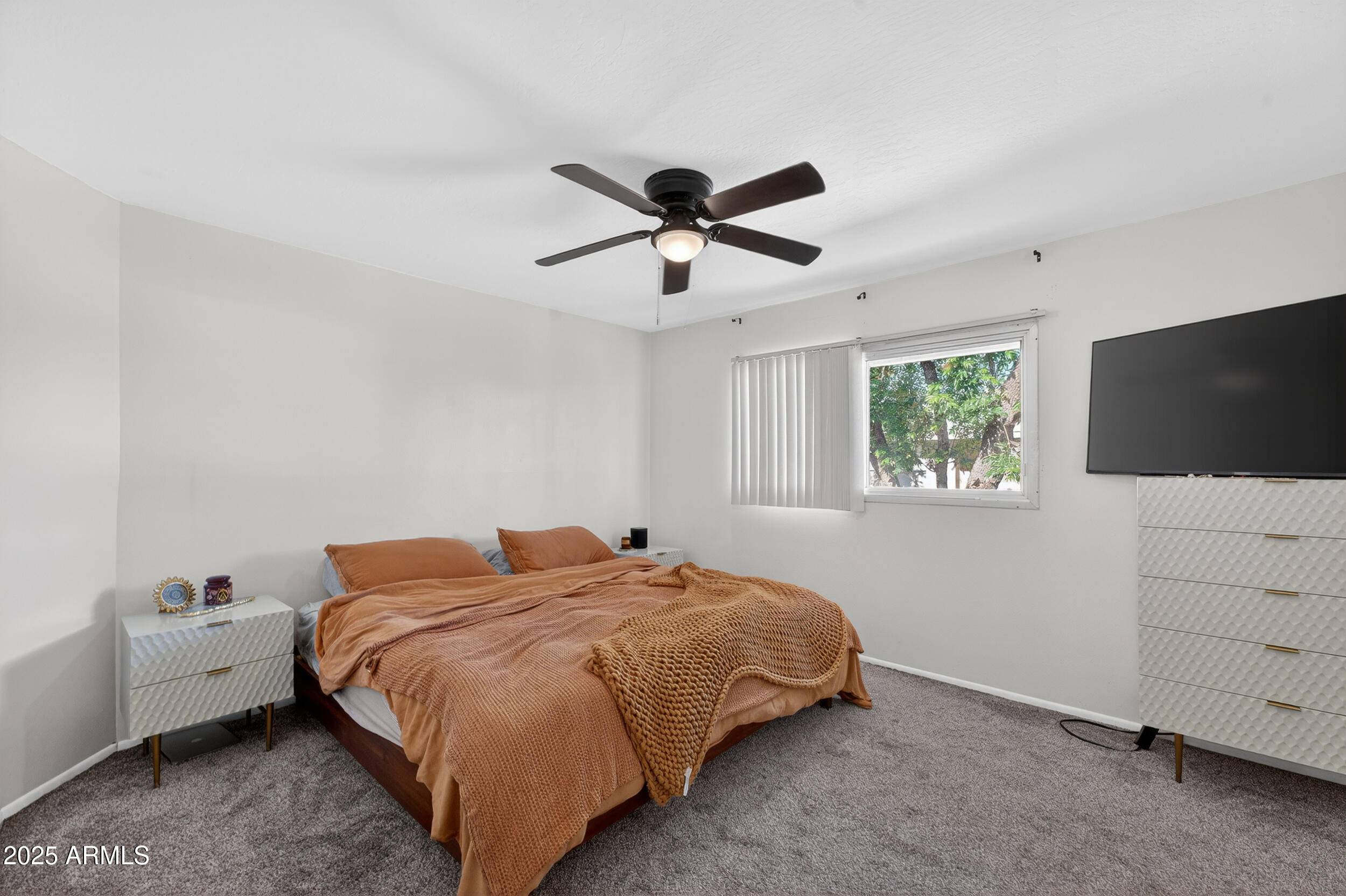 3929 South Mill Avenue Tempe, AZ 85282 - Photo 11 of 26 a bedroom with a bed and a flat screen tv