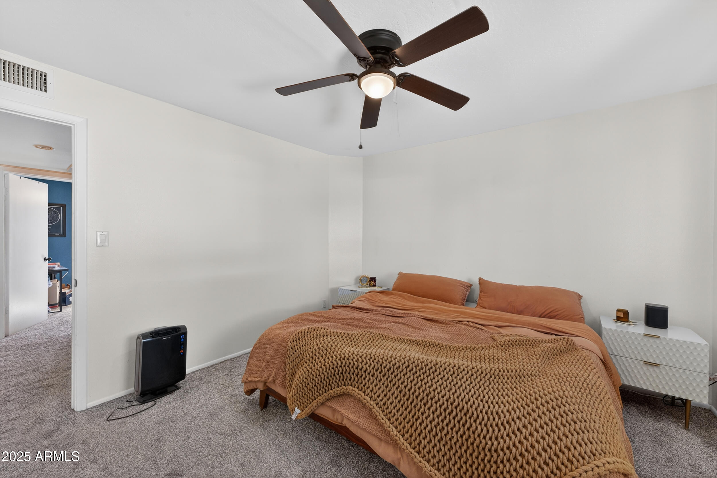 3929 South Mill Avenue Tempe, AZ 85282 - Photo 12 of 26 a bedroom with a bed and a chandelier