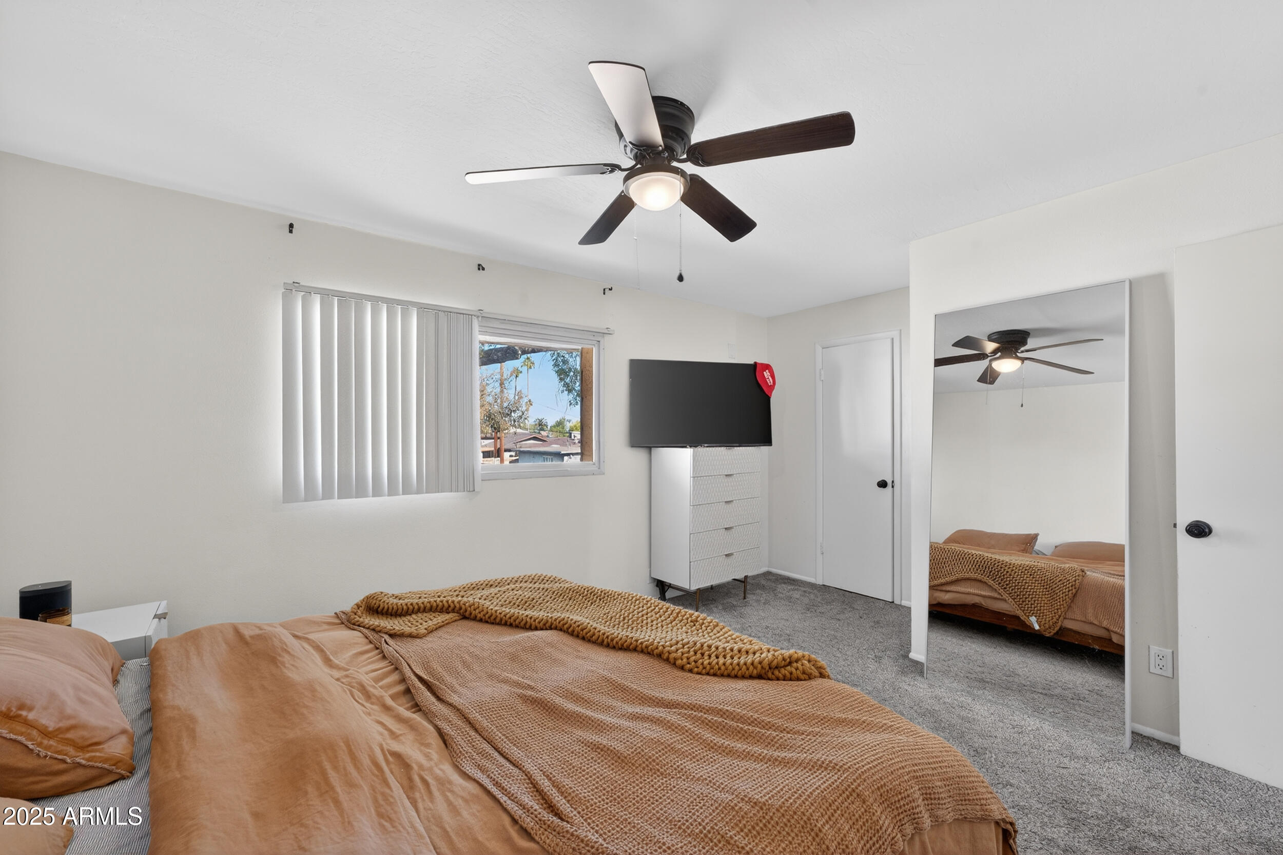 3929 South Mill Avenue Tempe, AZ 85282 - Photo 13 of 26 a bedroom with a bed and a flat tv screen on dresser