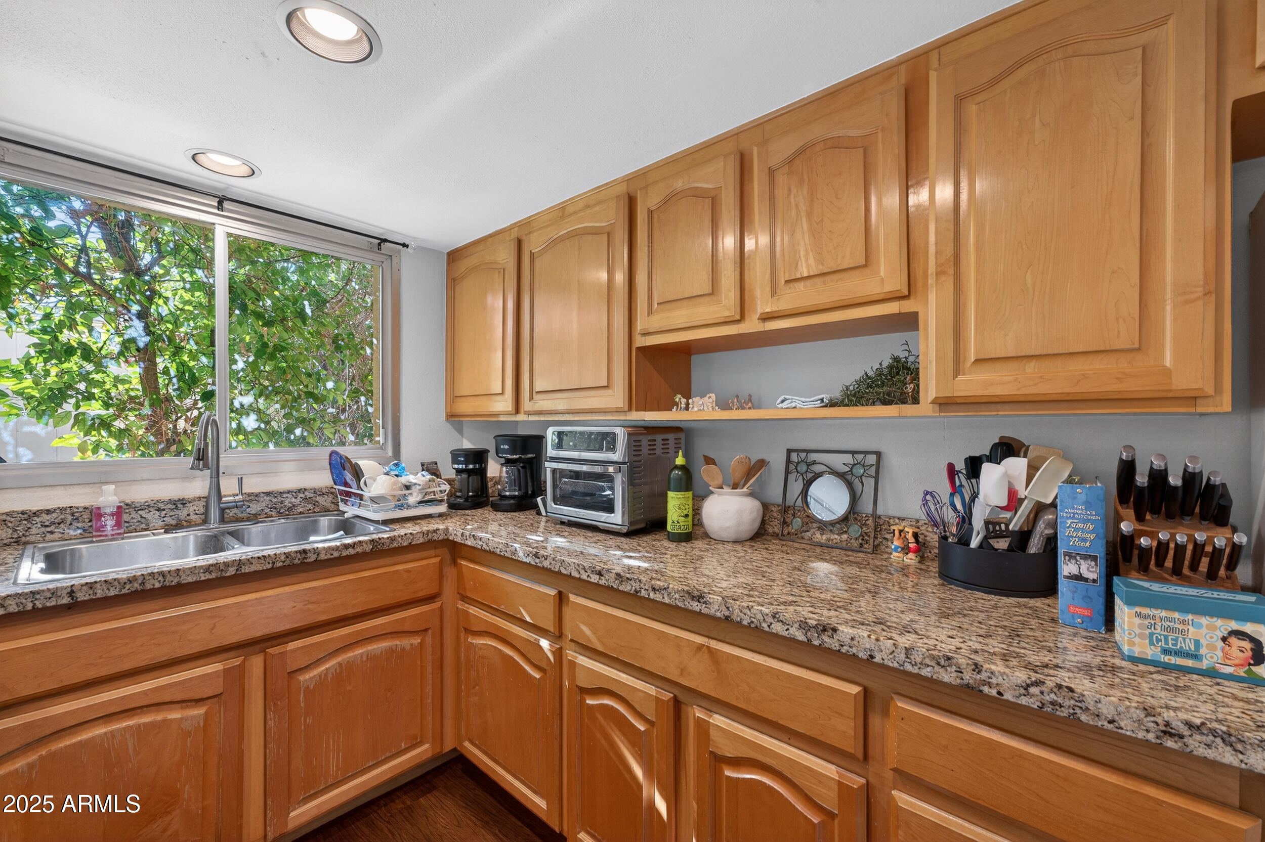 3929 South Mill Avenue Tempe, AZ 85282 - Photo 5 of 26 a kitchen with granite countertop stainless steel appliances a sink window and cabinets