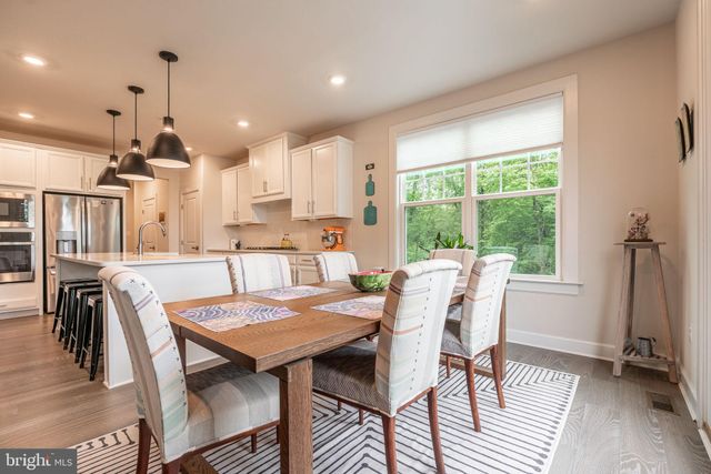 a view of a dining room with furniture and a window