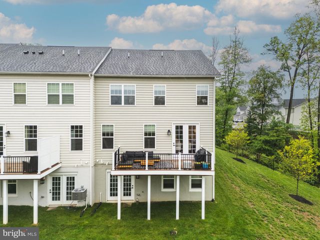 a aerial view of a house with a yard and potted plants