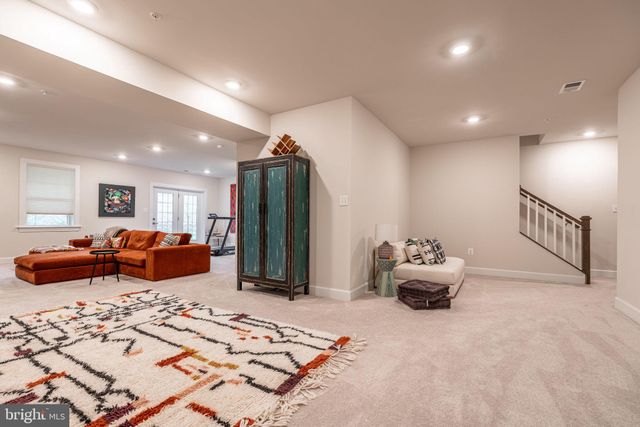 a bedroom with furniture and a large window