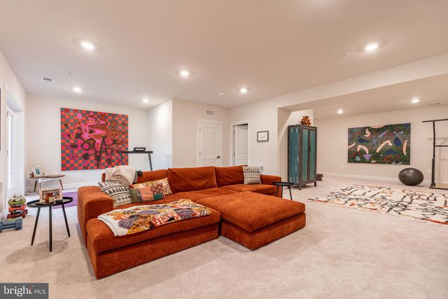 a living room with furniture and a large mirror with rug