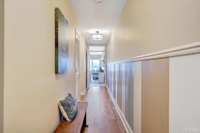 a view of a hallway with wooden floor