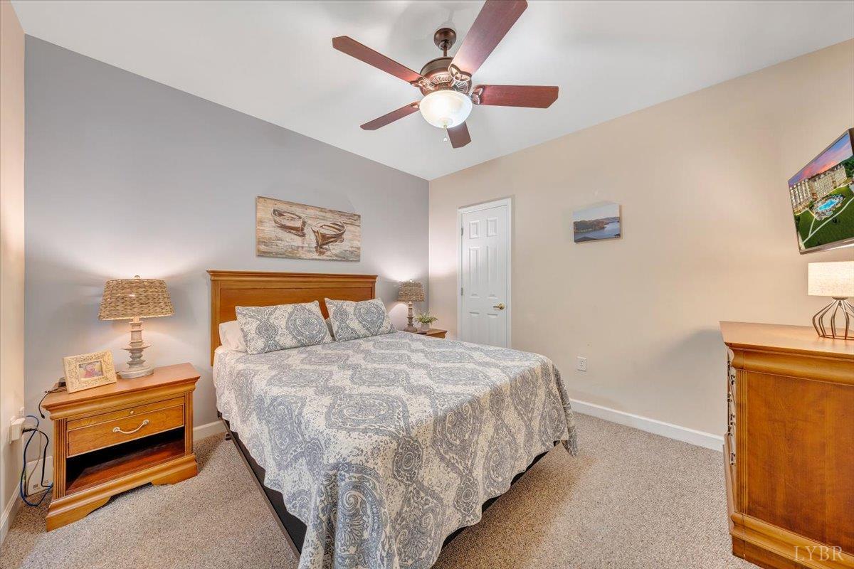 1273 Graves Harbor Trail, Unit 324 Huddleston, VA 24104 - Photo 13 of 25 a bedroom with a bed and a chandelier