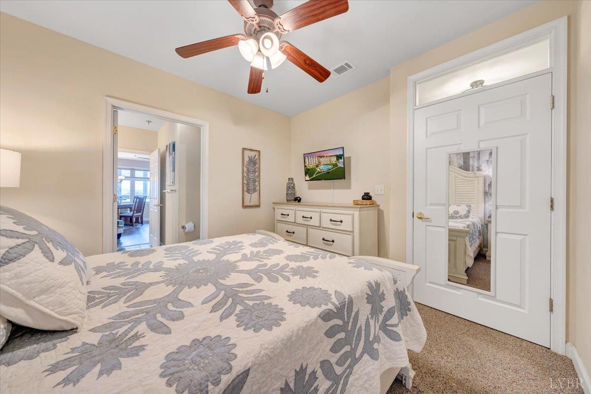 1273 Graves Harbor Trail, Unit 324 Huddleston, VA 24104 - Photo 20 of 25 a bedroom with a large bed and a chandelier