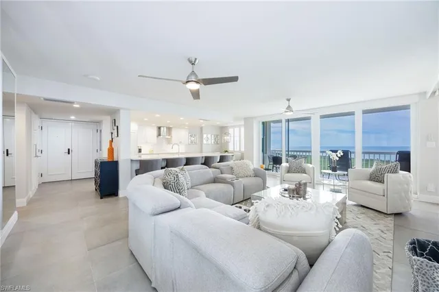 a living room with furniture ceiling fan and a rug
