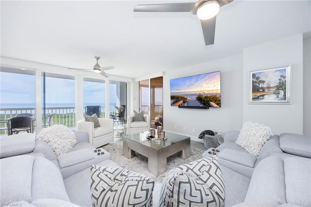 6573 Marissa Loop, Unit 2005 Naples, FL 34108 - Photo 12 of 25 a living room with furniture and a large window
