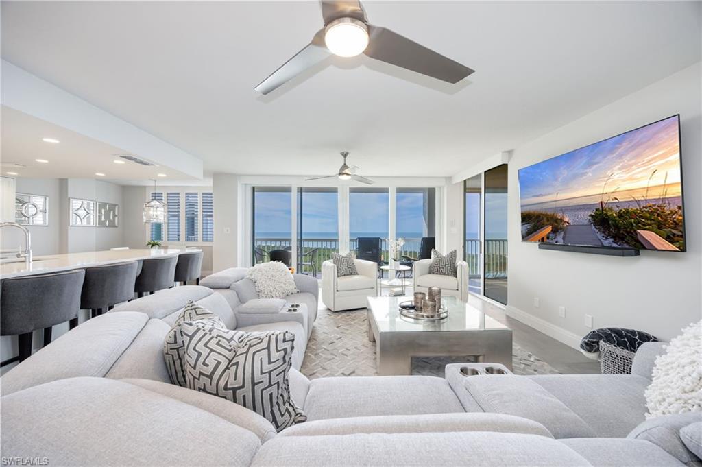 6573 Marissa Loop, Unit 2005 Naples, FL 34108 - Photo 13 of 25 a living room with furniture and a large window