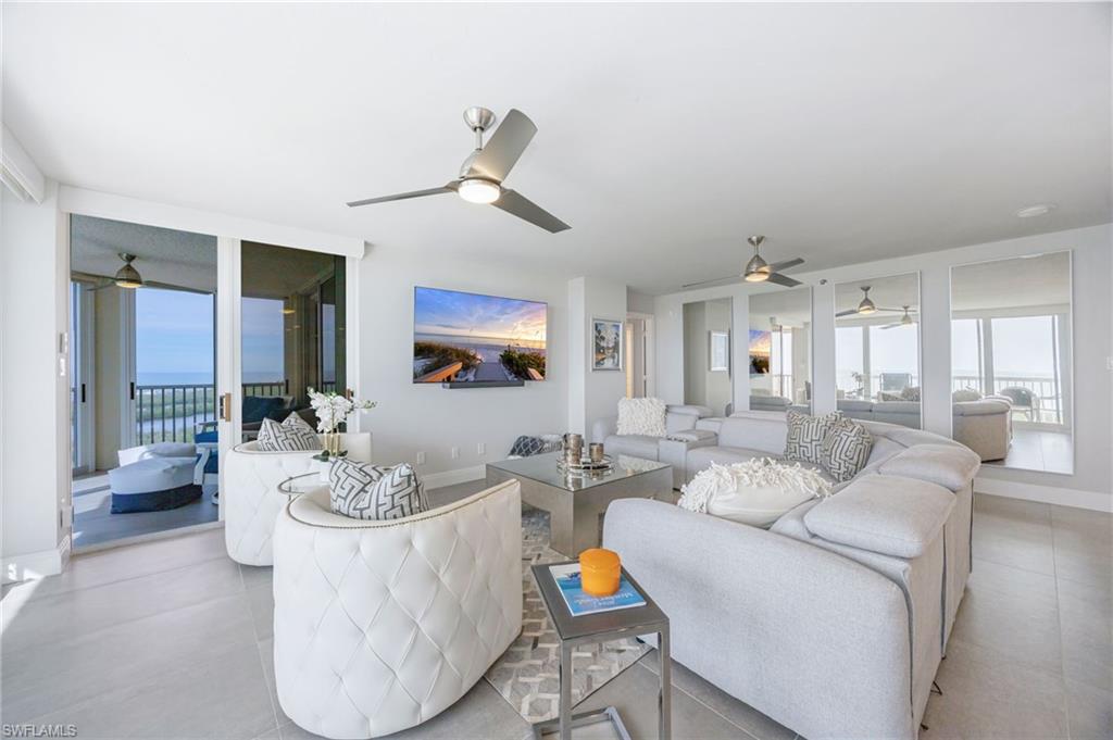 6573 Marissa Loop, Unit 2005 Naples, FL 34108 - Photo 14 of 25 a living room with furniture and a wooden floor