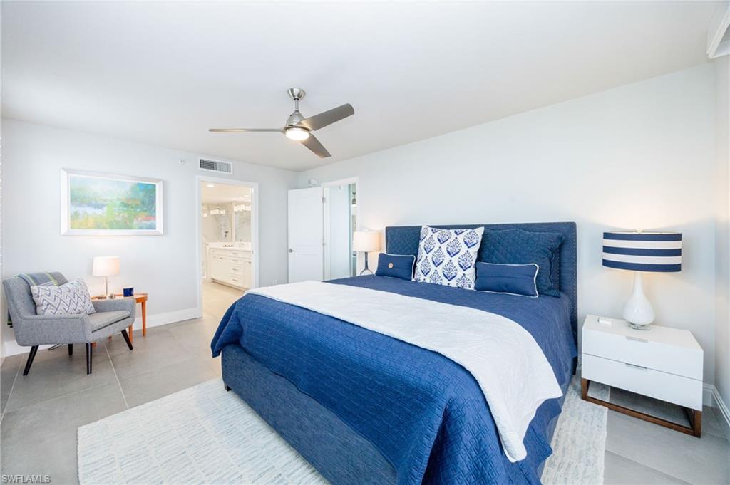 6573 Marissa Loop, Unit 2005 Naples, FL 34108 - Photo 16 of 25 a bedroom with a bed and a couch