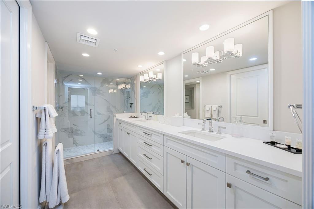 6573 Marissa Loop, Unit 2005 Naples, FL 34108 - Photo 18 of 25 a bathroom with a double vanity sink mirror and shower