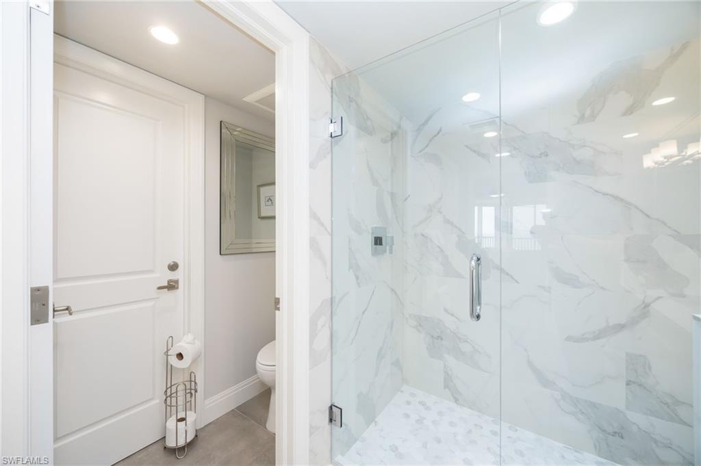 6573 Marissa Loop, Unit 2005 Naples, FL 34108 - Photo 19 of 25 a bathroom with a shower and a glass door