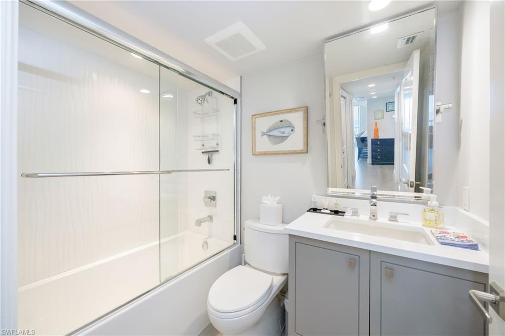 6573 Marissa Loop, Unit 2005 Naples, FL 34108 - Photo 22 of 25 a bathroom with a sink a toilet and shower