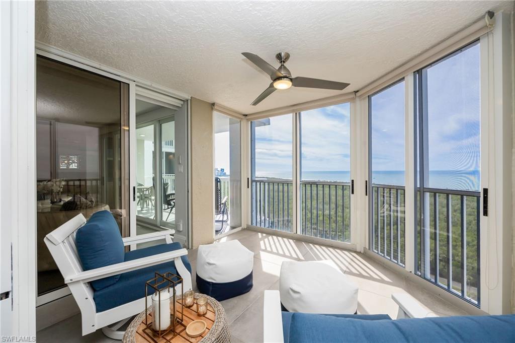 6573 Marissa Loop, Unit 2005 Naples, FL 34108 - Photo 4 of 25 a living room with wooden floor and a large window