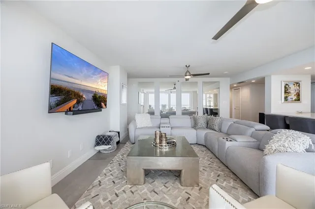 a living room with furniture and a painting on the wall