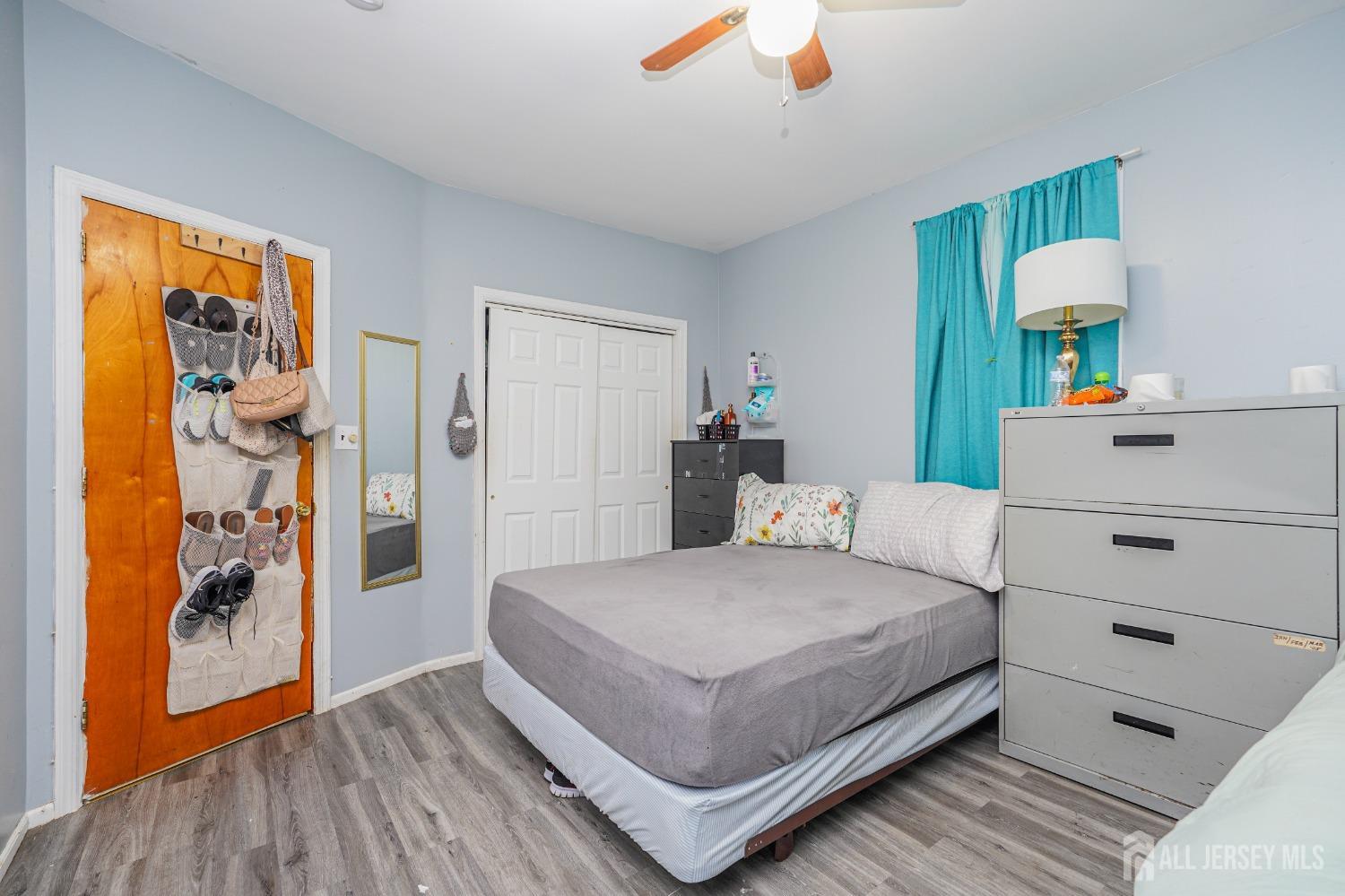 38 Handy Street New Brunswick, NJ 08901 - Photo 7 of 32 a bedroom with a bed and a dresser