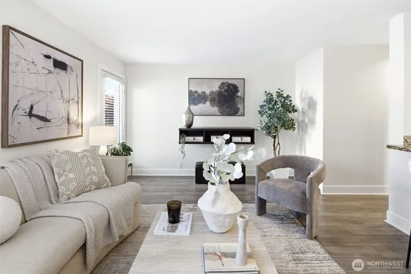 a living room with furniture flowerpot and window