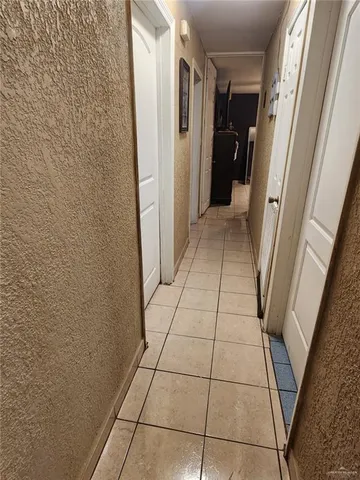 a bedroom with a bed and lamp on the dresser