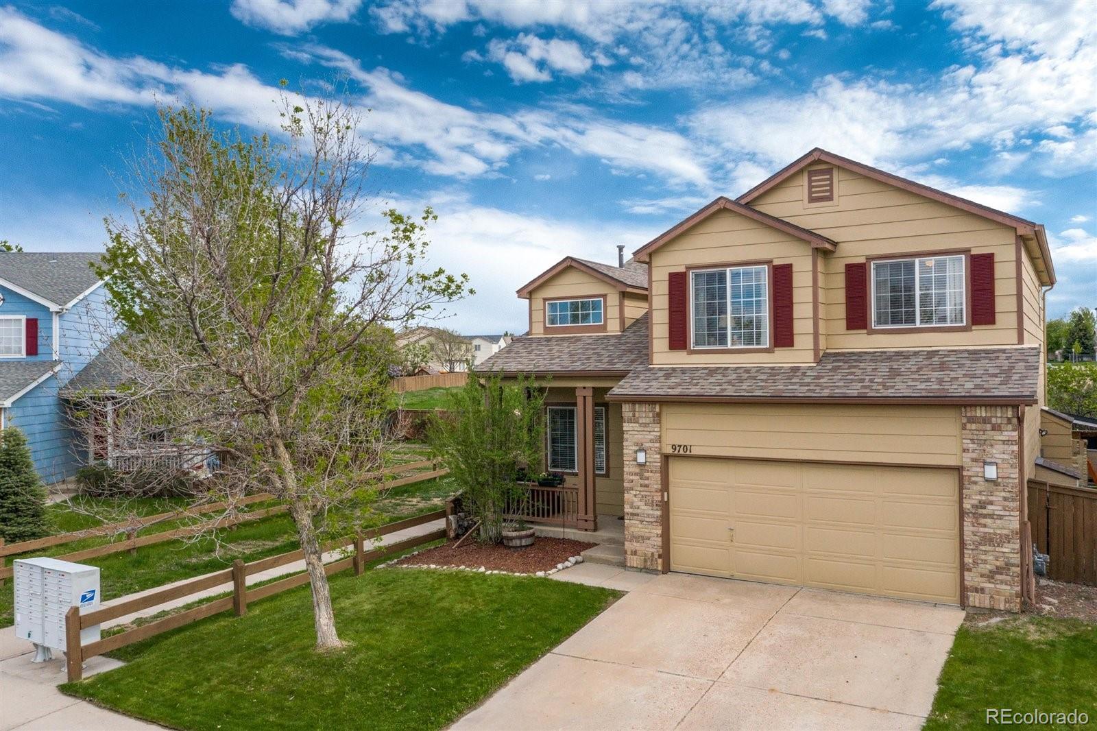 9701 Moss Rose Circle Highlands Ranch, CO 80129 - Photo 1 of 40 a front view of a house with a yard