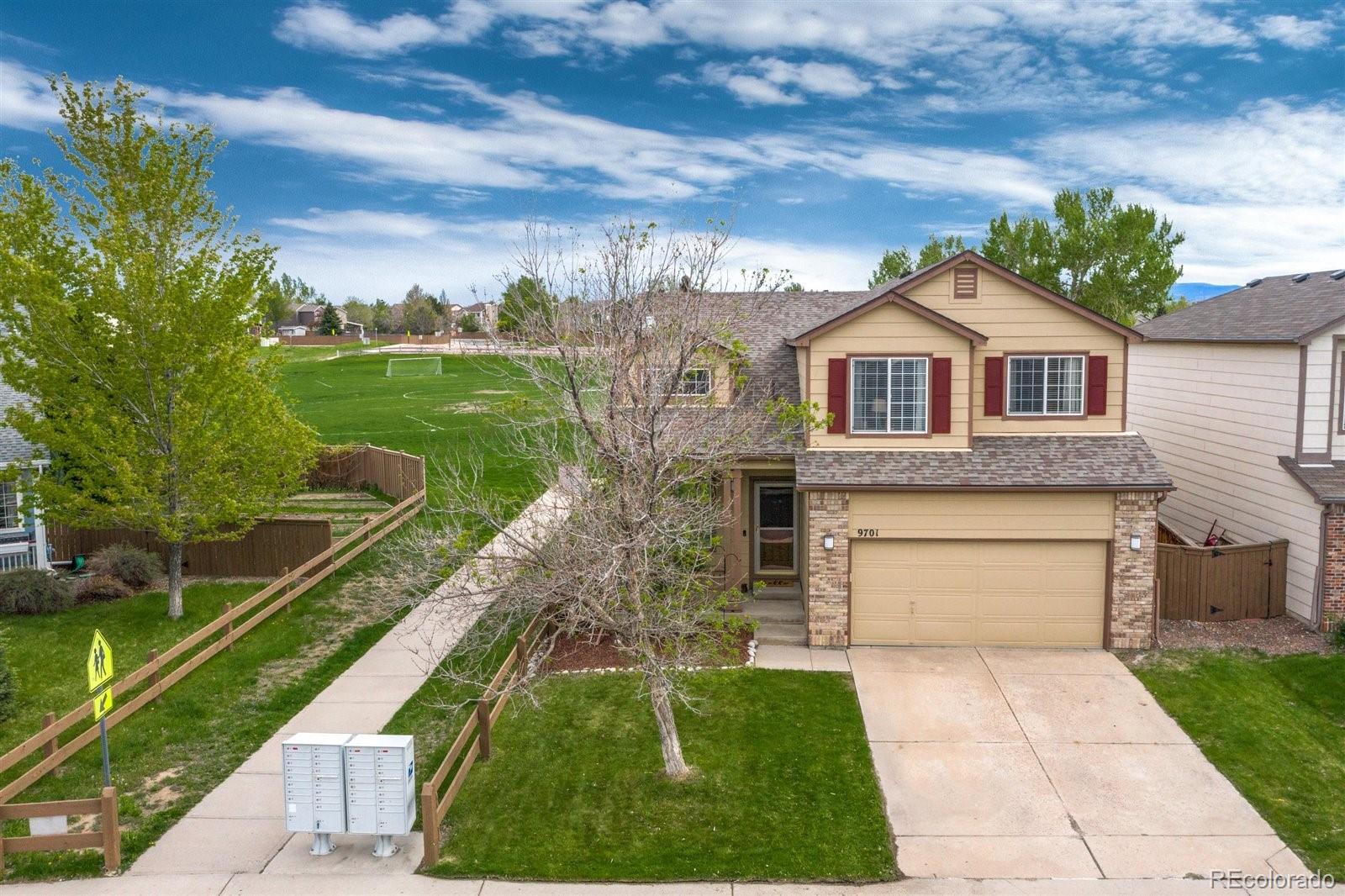9701 Moss Rose Circle Highlands Ranch, CO 80129 - Photo 2 of 40 a front view of a house with yard