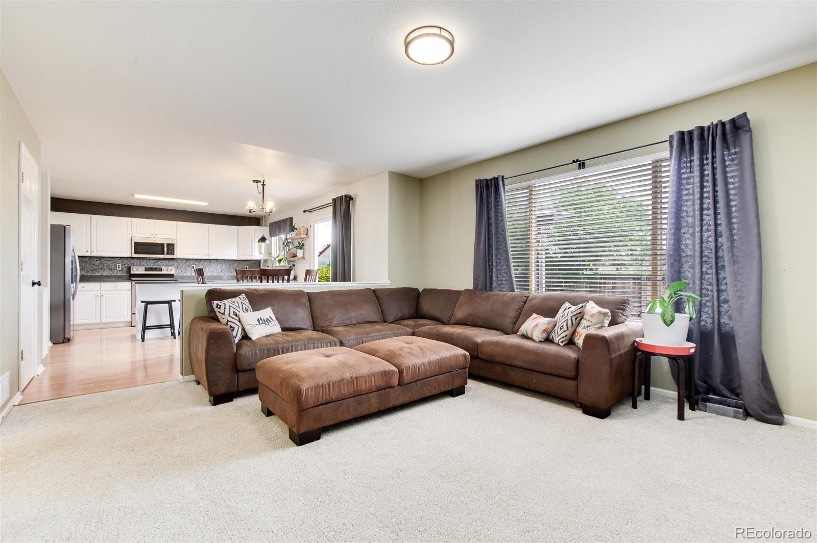 9701 Moss Rose Circle Highlands Ranch, CO 80129 - Photo 21 of 40 a living room with furniture and a large window