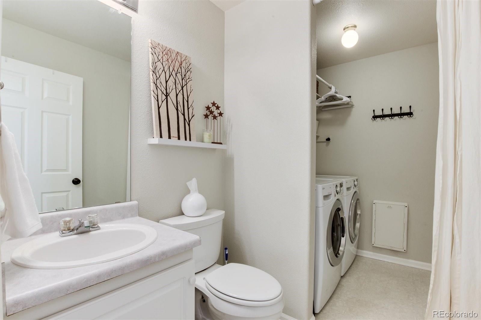 9701 Moss Rose Circle Highlands Ranch, CO 80129 - Photo 22 of 40 a bathroom with a sink a toilet and mirror