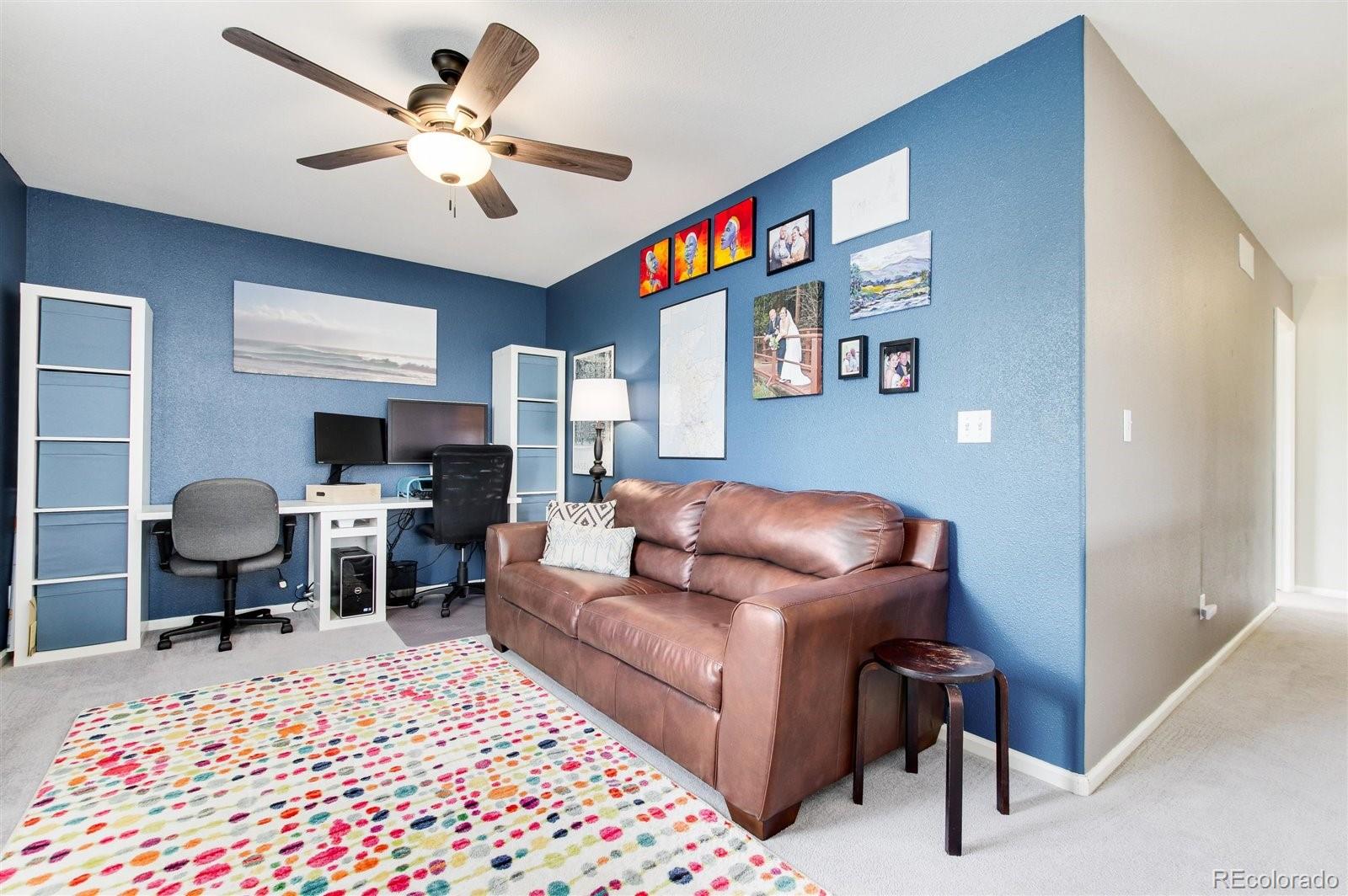 9701 Moss Rose Circle Highlands Ranch, CO 80129 - Photo 23 of 40 a living room with furniture and a rug