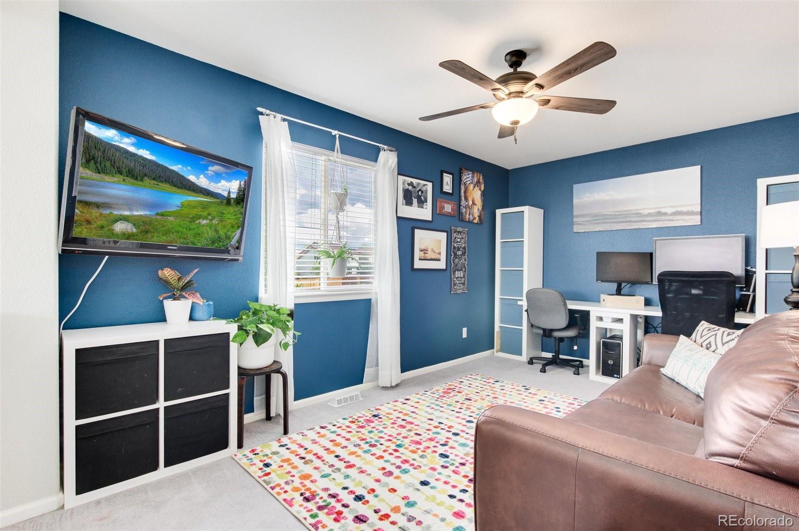 9701 Moss Rose Circle Highlands Ranch, CO 80129 - Photo 25 of 40 a bed room with a bed and a television