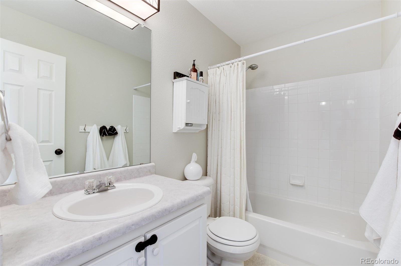 9701 Moss Rose Circle Highlands Ranch, CO 80129 - Photo 32 of 40 a bathroom with a sink a toilet and shower