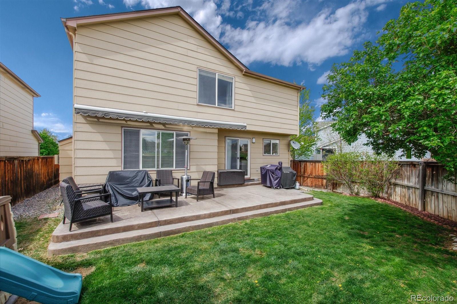 9701 Moss Rose Circle Highlands Ranch, CO 80129 - Photo 36 of 40 a view of a house with backyard and sitting area