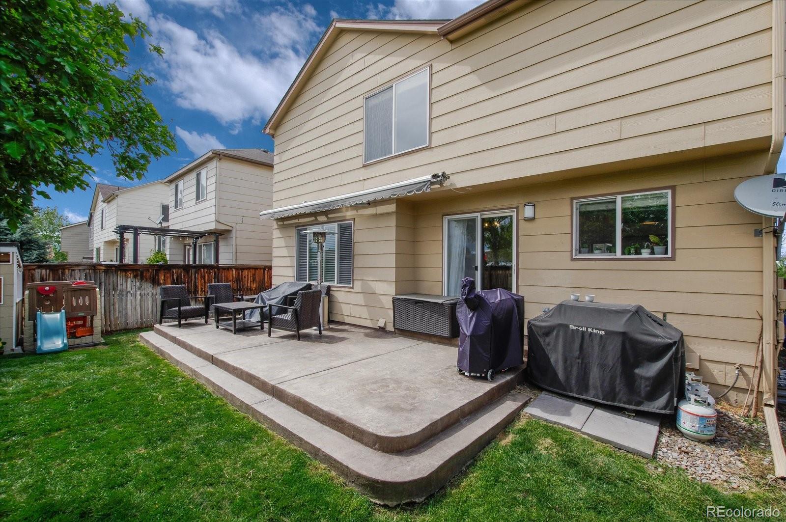 9701 Moss Rose Circle Highlands Ranch, CO 80129 - Photo 37 of 40 a view of a backyard with chairs and a patio