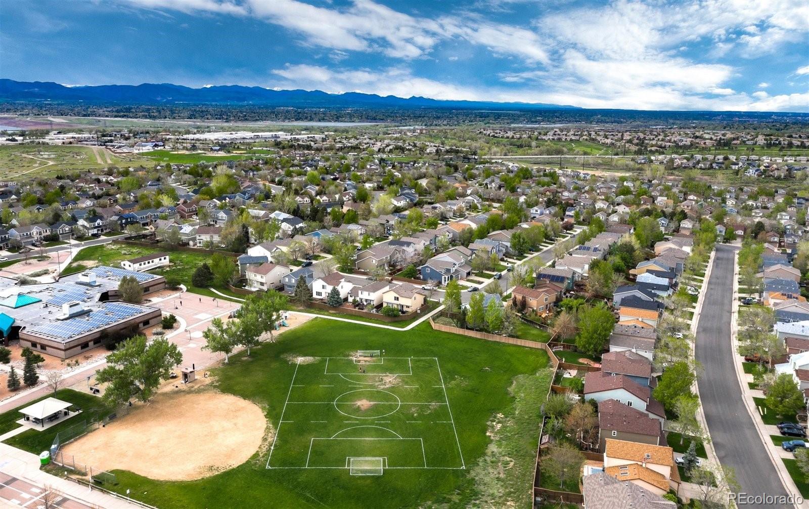 9701 Moss Rose Circle Highlands Ranch, CO 80129 - Photo 4 of 40 an aerial view of residential houses with outdoor space and trees